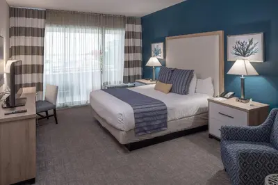 a hotel room with a bed and a chair at Bay Club Hotel and Marina in San Diego