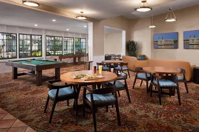 a hotel room with tables and a pool table at Bahia Resort Hotel in San Diego
