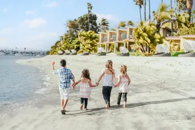 a family walking on the beach at Bahia Resort Hotel in San Diego