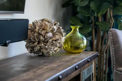 a yellow vase and a pine cone on a table at Ocean View 3 Bedrooms Condo, just steps from the park, pier & water! in Imperial Beach