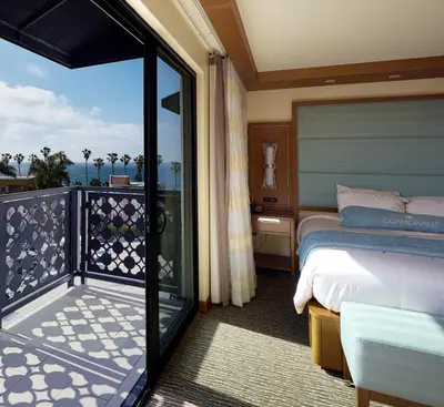 a hotel room with a bed and a balcony at Cormorant Boutique Hotel in San Diego