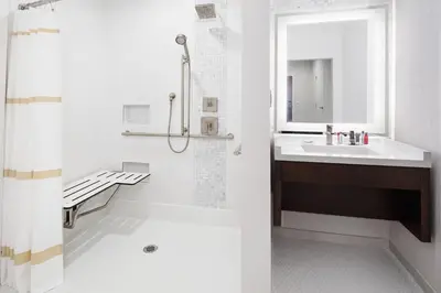 a white bathroom with a sink and a shower at San Diego Marriott Del Mar in San Diego