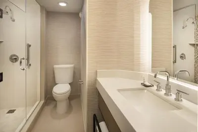 a bathroom with a toilet and a sink and a shower at Marriott Marquis San Diego Marina in San Diego