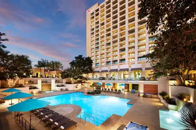 a large hotel with a large pool in front of a building at San Diego Marriott Mission Valley in San Diego