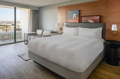 a bedroom with a large bed and a living room at San Diego Marriott Mission Valley in San Diego