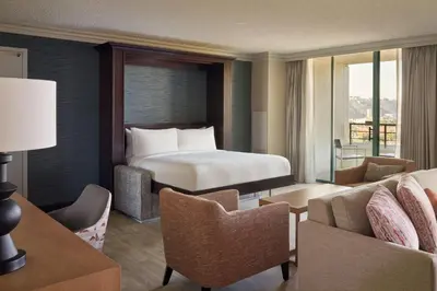 a hotel room with a bed and chairs at San Diego Marriott Mission Valley in San Diego