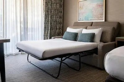 a large bed in a hotel room with a couch at Coronado Island Marriott Resort & Spa in San Diego