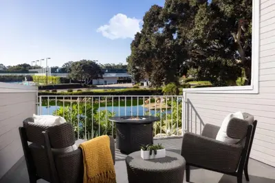 a porch with chairs and a table and a view of the water at Coronado Island Marriott Resort & Spa in San Diego
