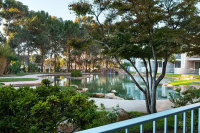 a view from the balcony of a park with a pond at Coronado Island Marriott Resort & Spa in San Diego