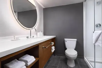 a bathroom with a white toilet and a mirror at Courtyard by Marriott San Diego Mission Valley/Hotel Circle in San Diego