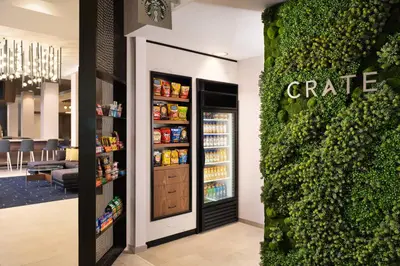 a coffee shop with a green wall next to a store at Courtyard by Marriott San Diego Mission Valley/Hotel Circle in San Diego