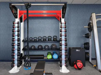 a gym with a rack of weights and dumbbells at Courtyard by Marriott San Diego Mission Valley/Hotel Circle in San Diego