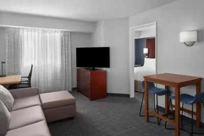a living room with a couch and a television in a hotel room at Residence Inn by Marriott San Diego Downtown in San Diego
