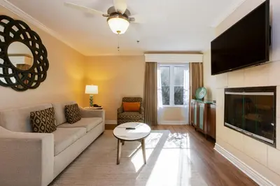 a living room with a couch and a tv at Coronado Beach Resort in San Diego