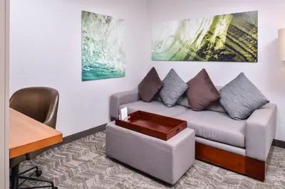 a living room with a couch and a table at SpringHill Suites Temecula Valley Wine Country in Temecula