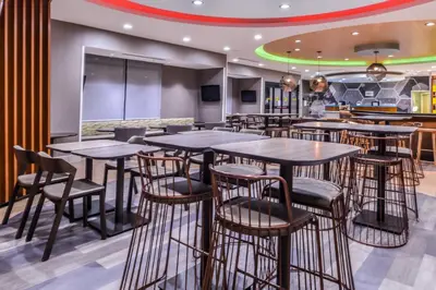 a bar with tables and chairs in a restaurant at SpringHill Suites Temecula Valley Wine Country in Temecula