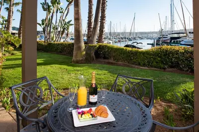 a table with a plate of food and two bottles of wine at Humphreys Half Moon Inn in San Diego