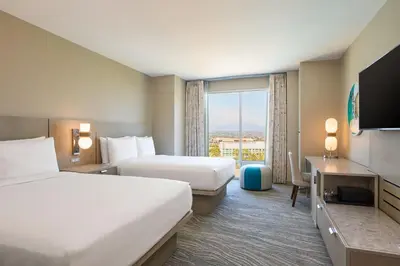 a hotel room with two beds and a large window at Renaissance ClubSport Aliso Viejo Laguna Beach Hotel in Aliso Viejo