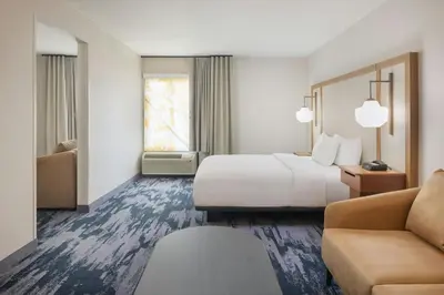 a hotel room with a bed and a couch at Fairfield by Marriott Mission Viejo Orange County in Mission Viejo