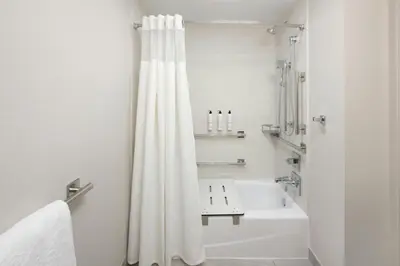 a bathroom with a white shower curtain and a sink at Fairfield by Marriott Mission Viejo Orange County in Mission Viejo