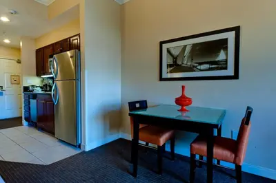 a kitchen with a table and a refrigerator at Club Wyndham Harbour Lights in San Diego