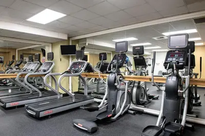 a gym with several rows of tread machines at Club Wyndham Harbour Lights in San Diego