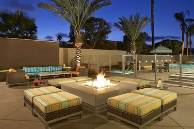 a patio with two beds and a fire pit at Hampton Inn San Diego Mission Valley in San Diego