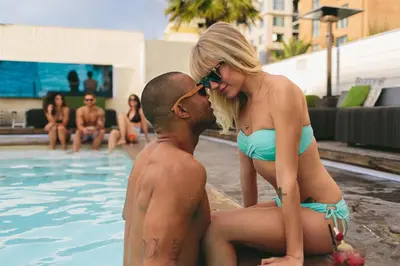 a man and a woman sitting in a swimming pool at Hard Rock Hotel San Diego in San Diego