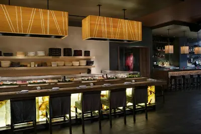 a restaurant with a bar with chairs and lights at Hard Rock Hotel San Diego in San Diego