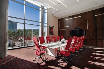 a conference room with a white table and red chairs at Hard Rock Hotel San Diego in San Diego