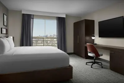 a hotel room with a bed and a desk and a television at Courtyard by Marriott San Diego Downtown Little Italy in San Diego