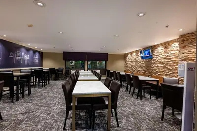 a dining room with tables and chairs and a tv at Hampton Inn by Hilton San Diego - Kearny Mesa in San Diego