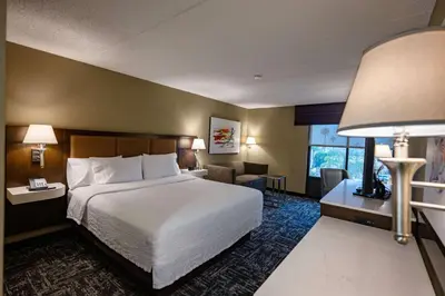 a hotel room with a bed and a living room at Hampton Inn by Hilton San Diego - Kearny Mesa in San Diego