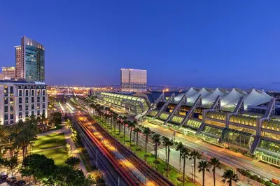 a city at night with a train station and buildings at Hilton San Diego Gaslamp Quarter in San Diego