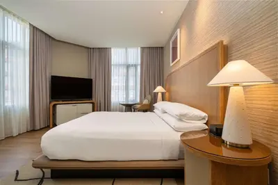 a hotel room with a bed and a television at Hilton San Diego Gaslamp Quarter in San Diego
