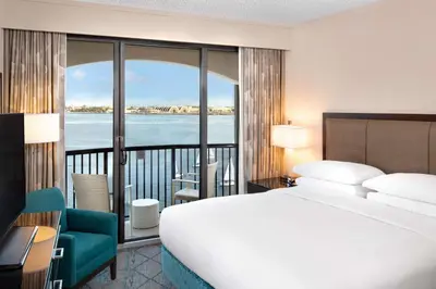 a bedroom with a bed and a view of the water at Hilton San Diego Airport/Harbor Island in San Diego
