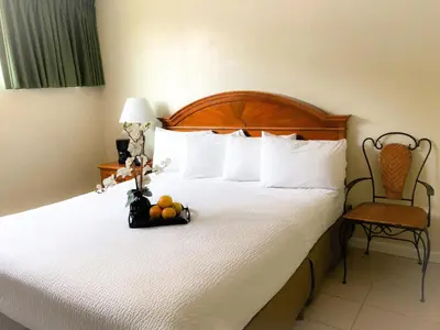 a hotel room with a bed with a bowl of fruit on it at Americas Best Value Inn Loma Lodge in San Diego
