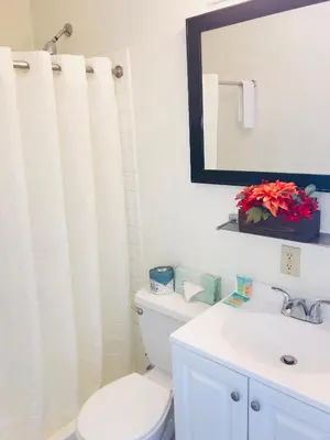 a bathroom with a toilet and a sink and a mirror at Americas Best Value Inn Loma Lodge in San Diego