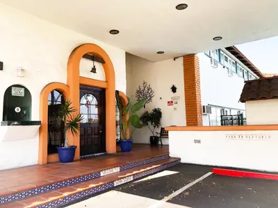 a entrance to a building with a door and potted plants at Americas Best Value Inn Loma Lodge in San Diego