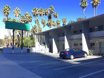 a car parked in front of a building with a street sign at Downtown San Diego Lodge in San Diego