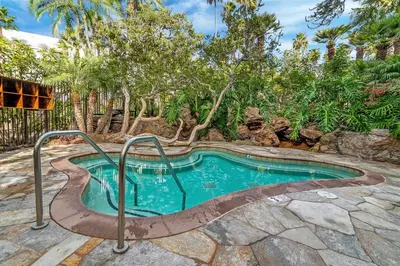a swimming pool in a yard with trees at Condo in Beachfront Resort B-212 in Oceanside