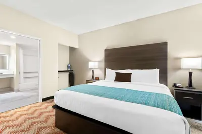 a hotel room with a large bed and a large mirror at Best Western Plus Irvine Spectrum Hotel in Lake Forest