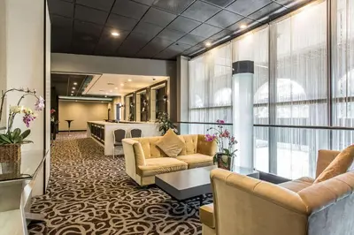 a lobby with two couches and a salon at voco Laguna Hills by IHG in Laguna Hills
