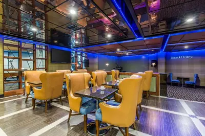 a restaurant with tables and chairs in a room at voco Laguna Hills by IHG in Laguna Hills