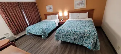 a hotel room with two beds and a window at Harvey's Motel SDSU La Mesa San Diego in San Diego