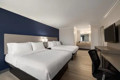 a hotel room with two beds and a television at Quality Inn Lake Elsinore I-15 in Lake Elsinore