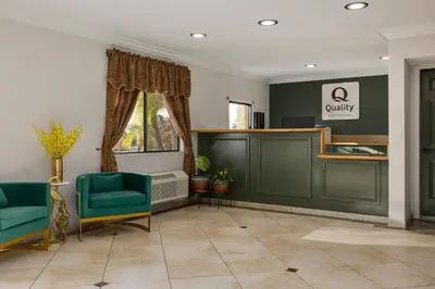 a waiting room with two green chairs and a counter at Quality Inn Lake Elsinore I-15 in Lake Elsinore