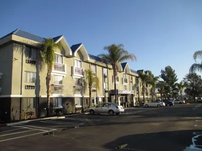 a street with cars parked in front of a building at Best Western Plus Diamond Valley Inn in Hemet