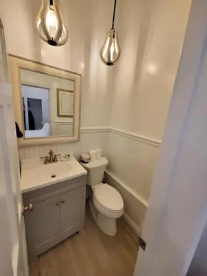 a bathroom with a toilet and a sink and a mirror at Sea Horse Resort in San Clemente