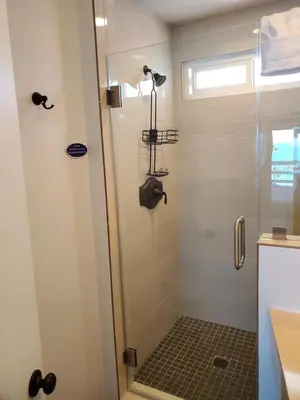 a bathroom with a shower with a glass door at Sea Horse Resort in San Clemente